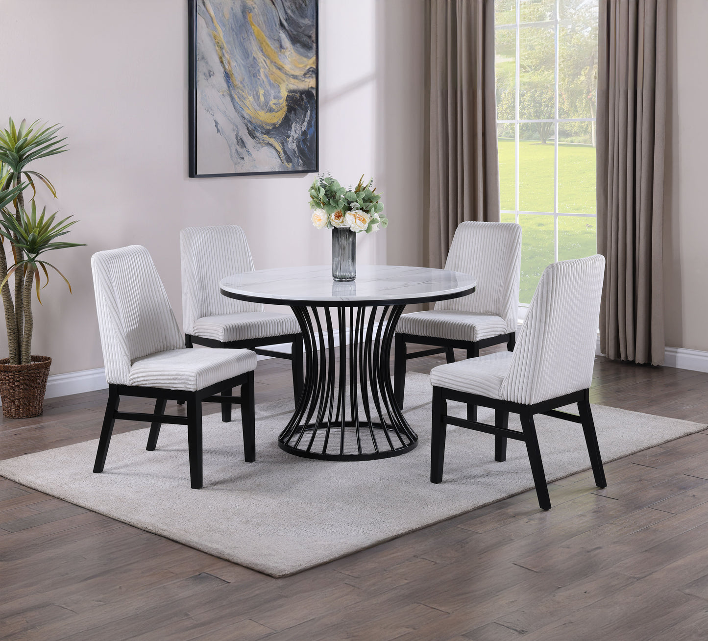 Round white marble dining table with black pedestal base and four white upholstered dining chairs