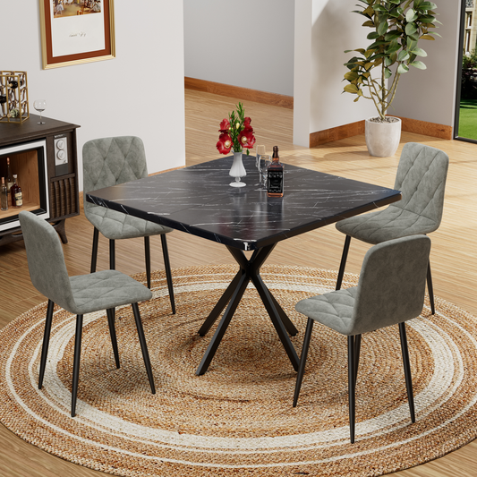 Black marble dining table with four grey upholstered chairs