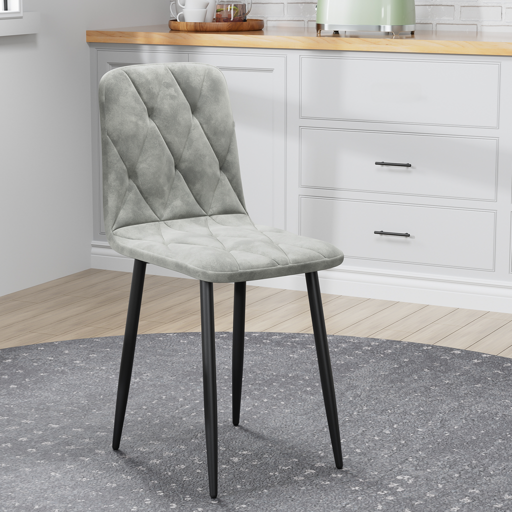 Quilted gray upholstered dining chair with black metal legs