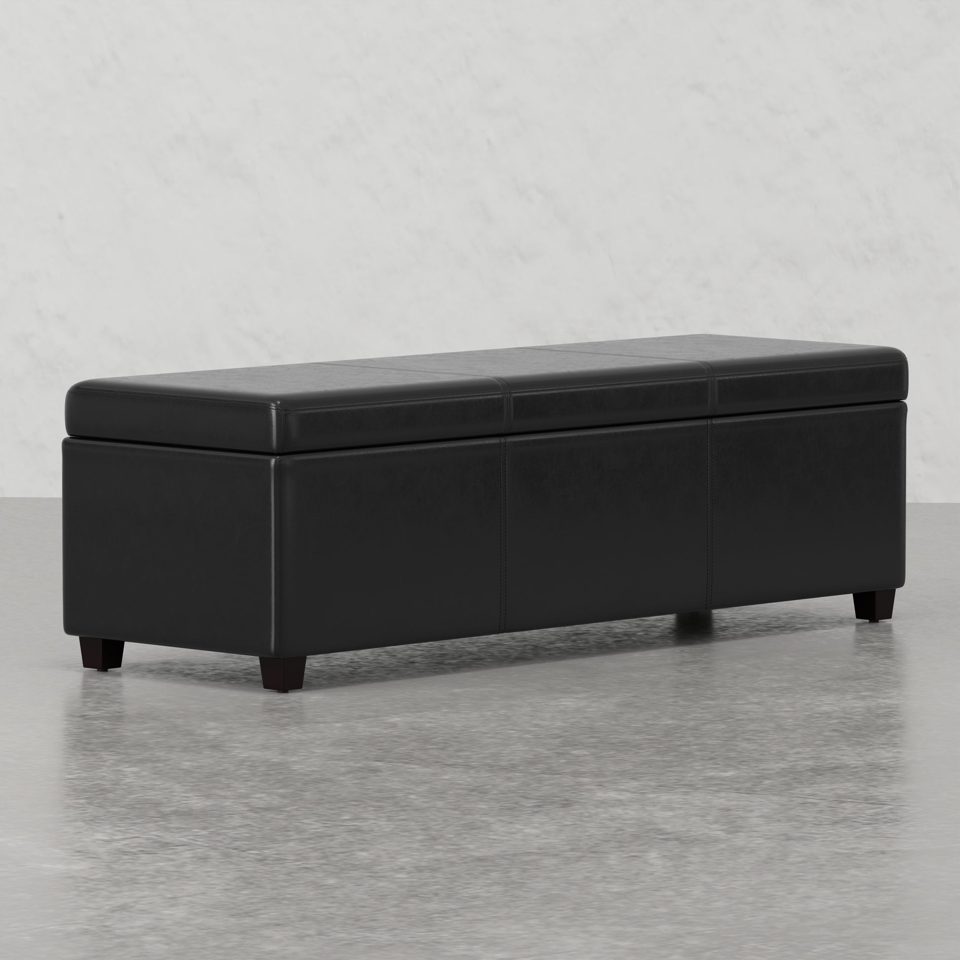 Black faux leather storage ottoman with stitching details