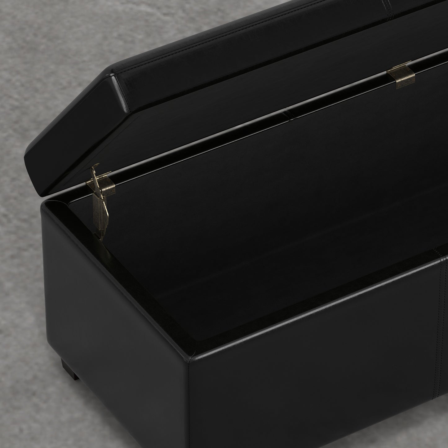 Black faux leather storage ottoman with hinged lid open