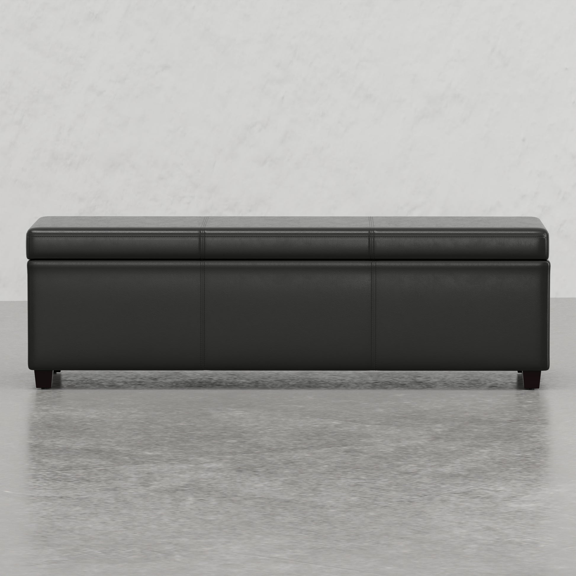Black faux leather storage ottoman with stitched lid
