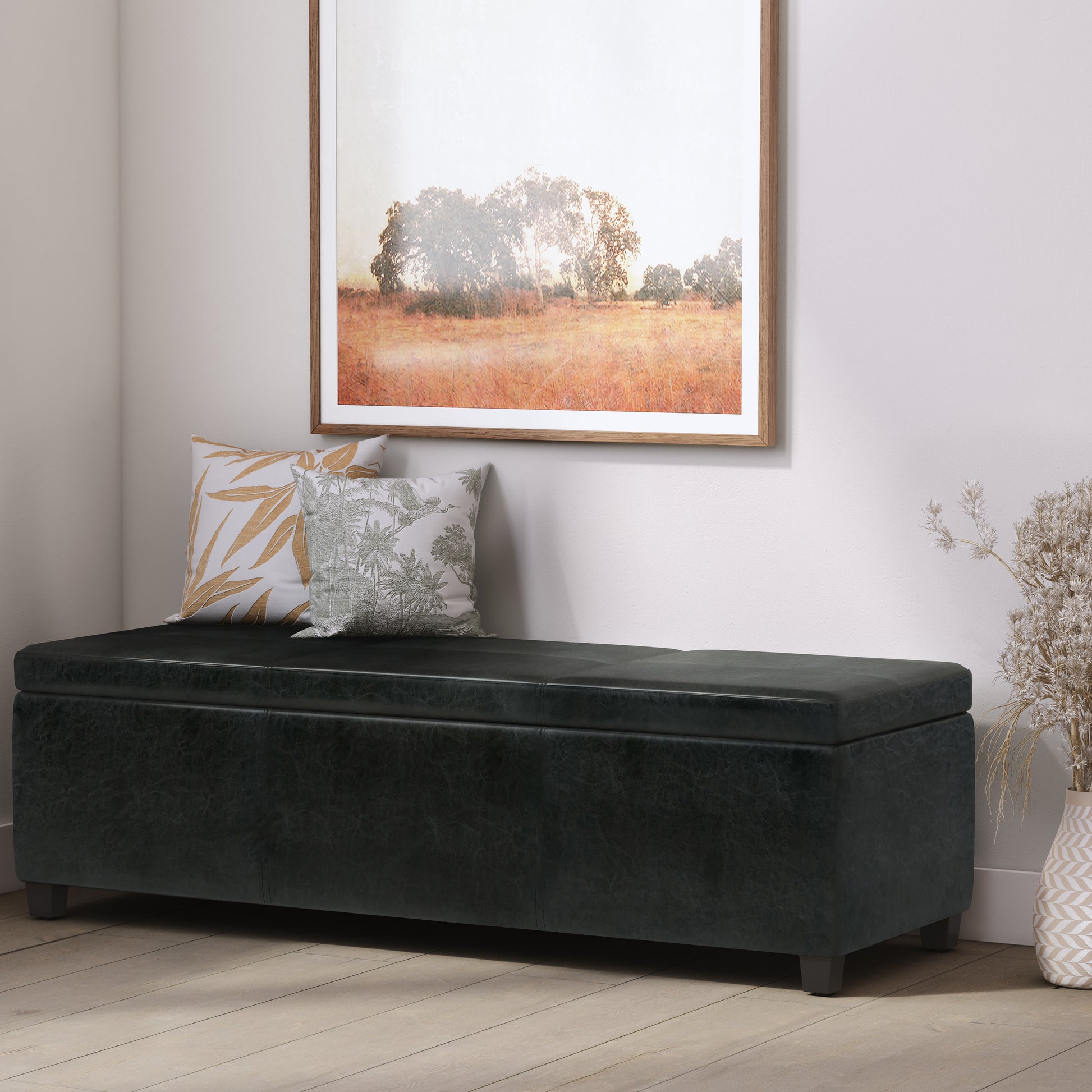 Black faux leather storage bench with hinged lid and modern tapered legs