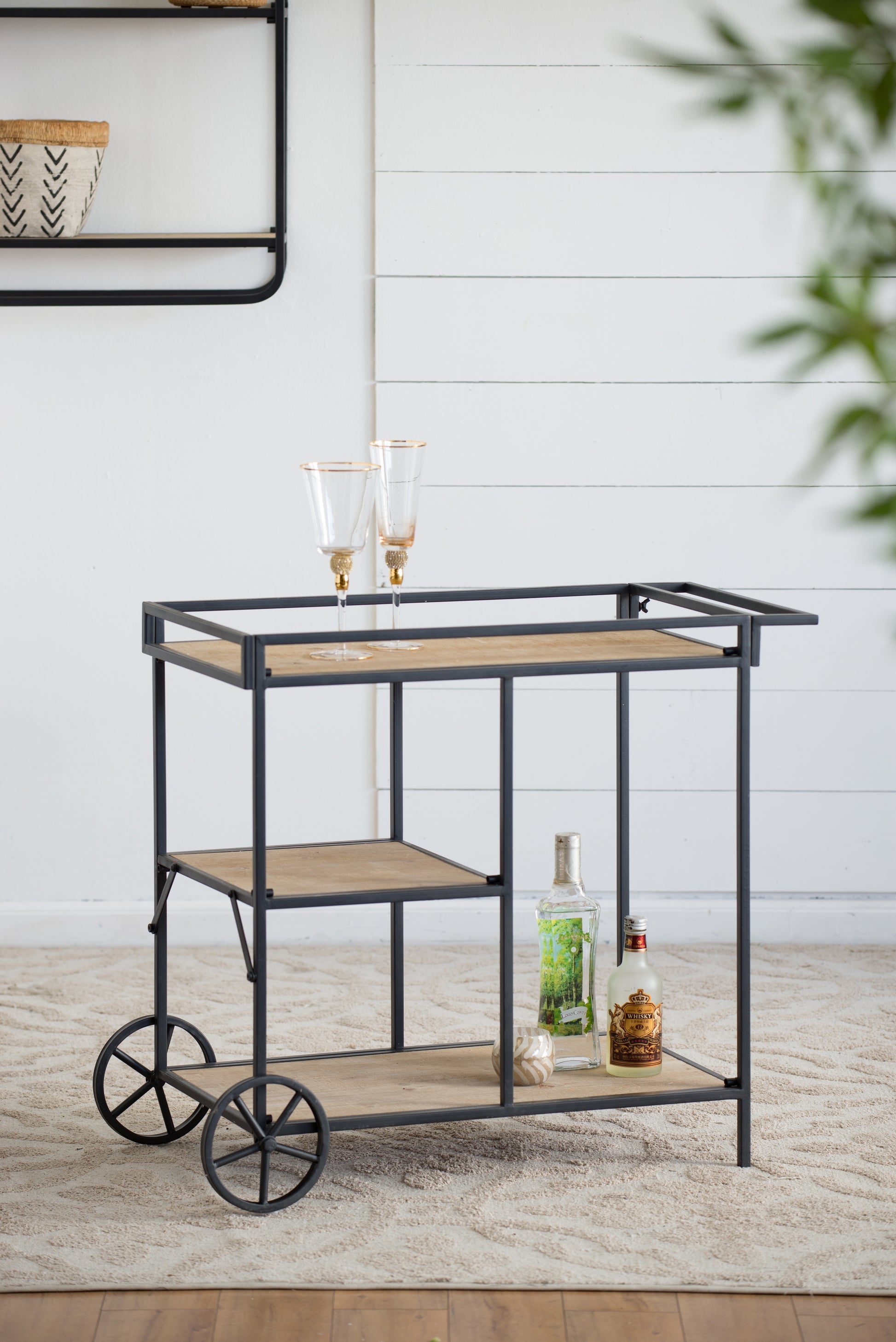 Modern industrial metal bar cart with wooden shelves and decorative wheels