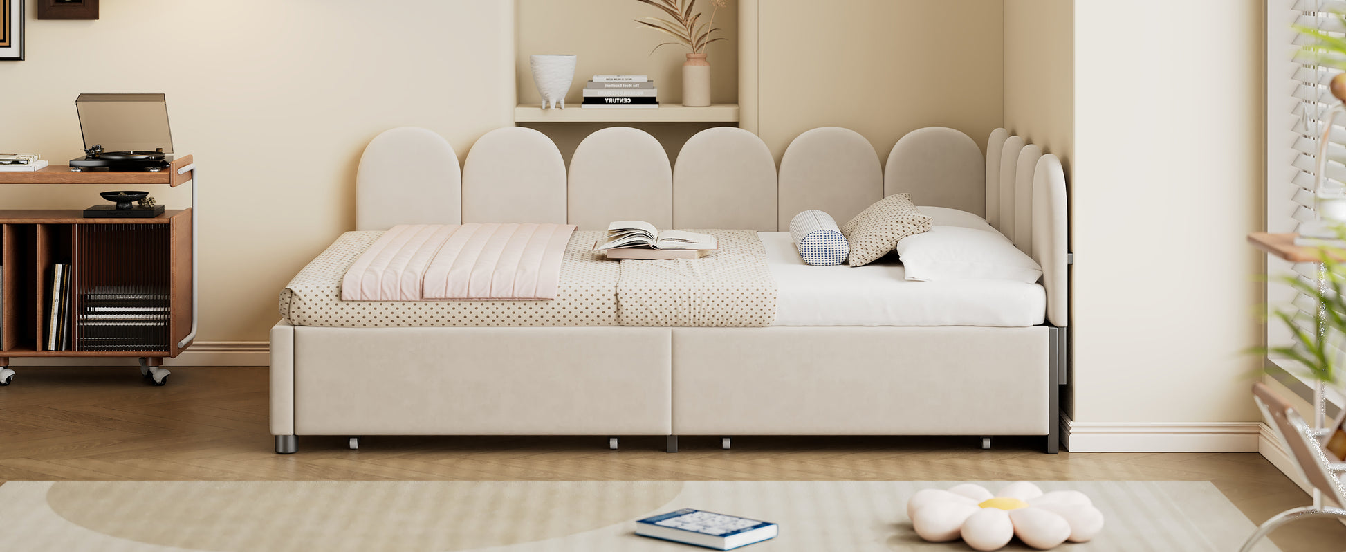 Cream velvet daybed with arched headboard and pink quilted throw