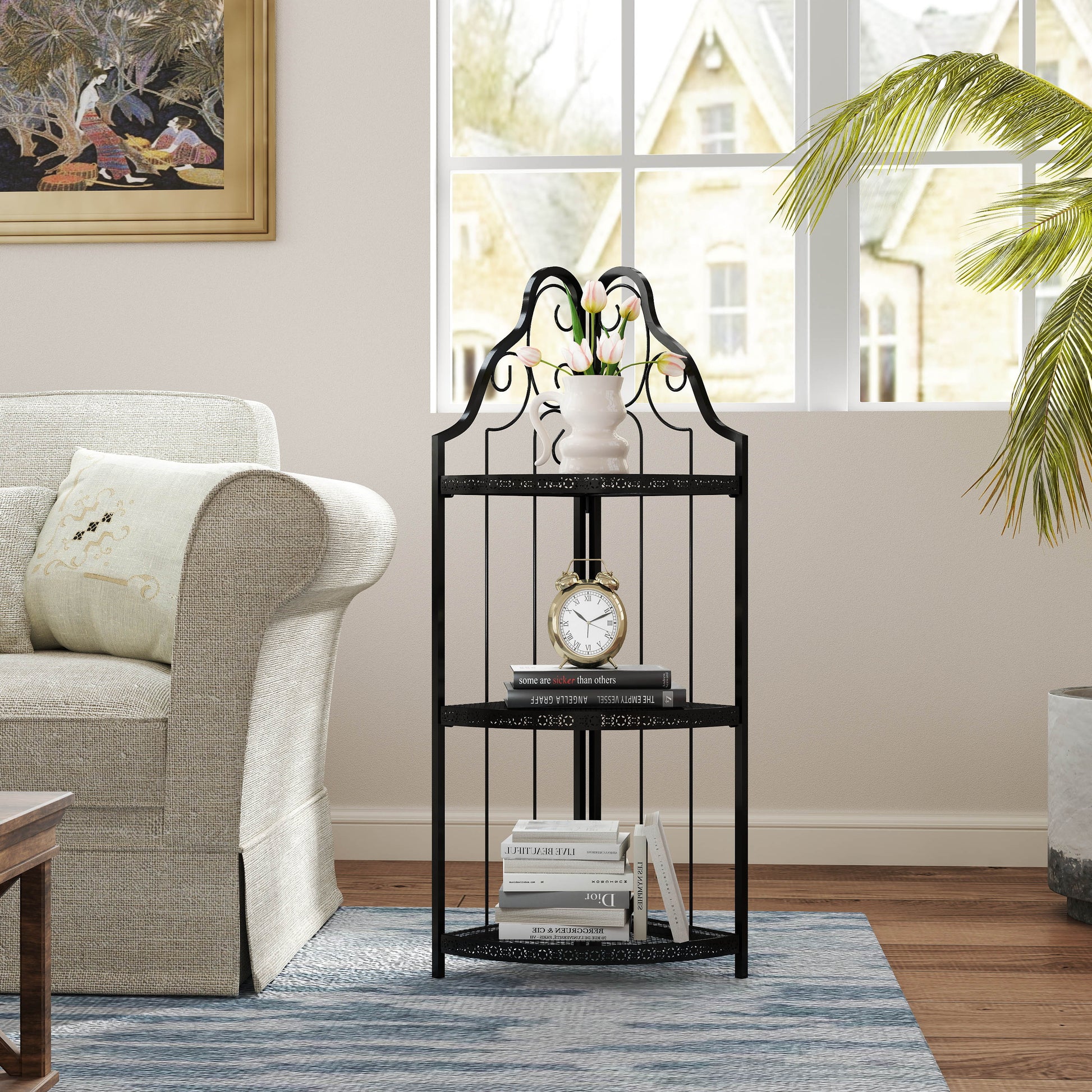 Elegant black metal corner shelf with decorative scrolls holding books and a vase