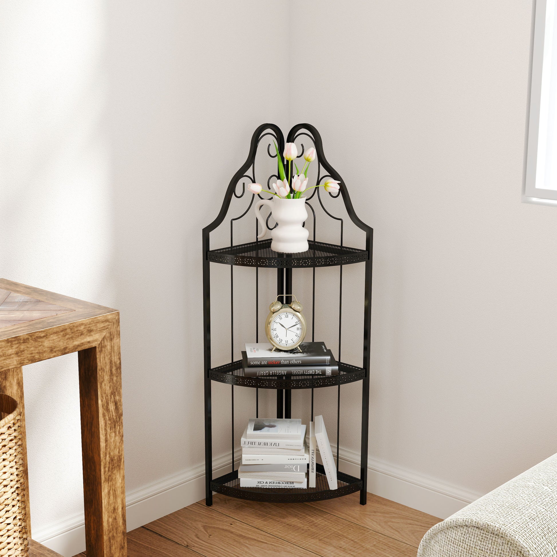Black wrought iron tier corner shelf with decorative scrollwork