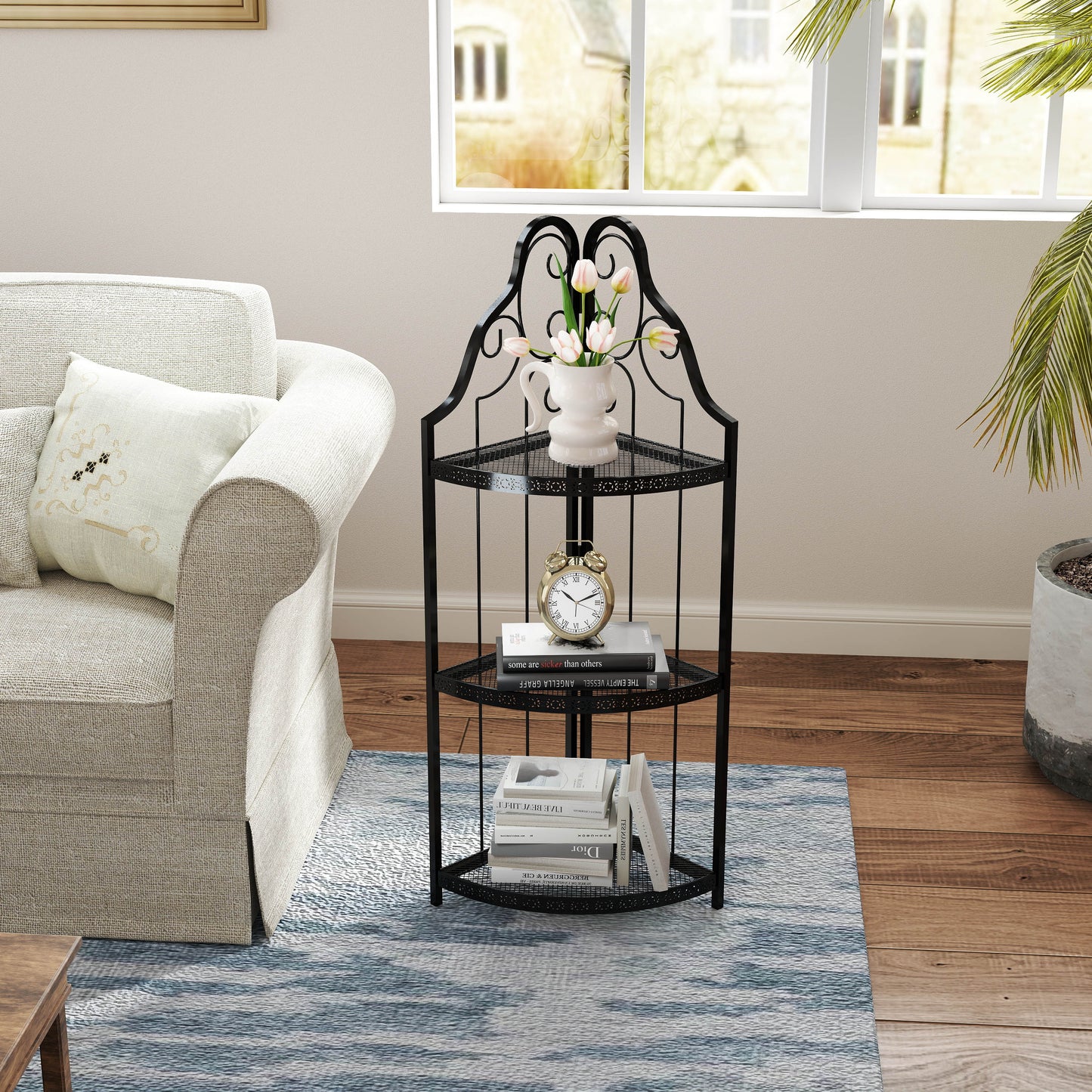 Black wrought iron corner shelf with three tiers ornate top and decorative base