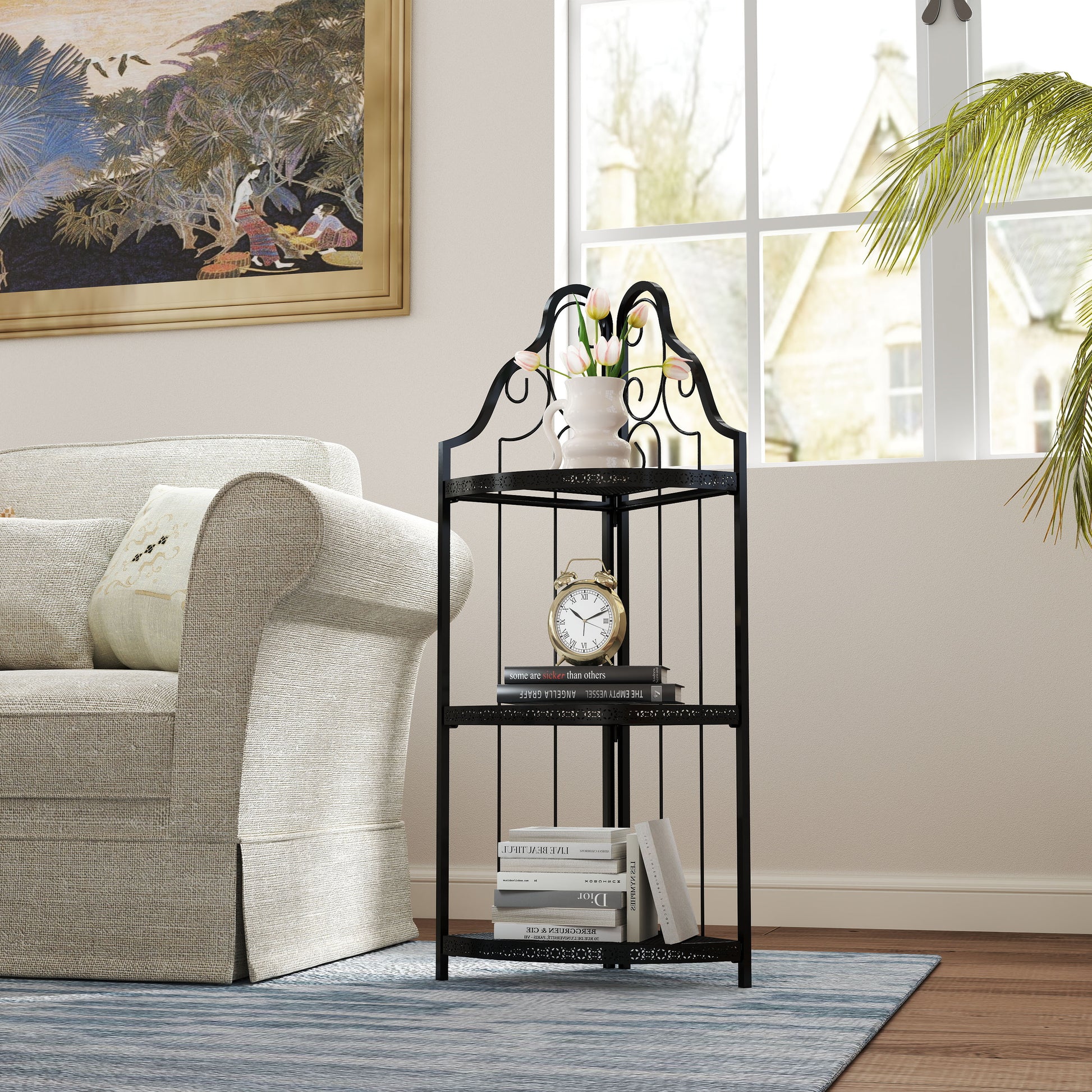 Black metal corner shelf with ornate scrolls and three tiered shelves