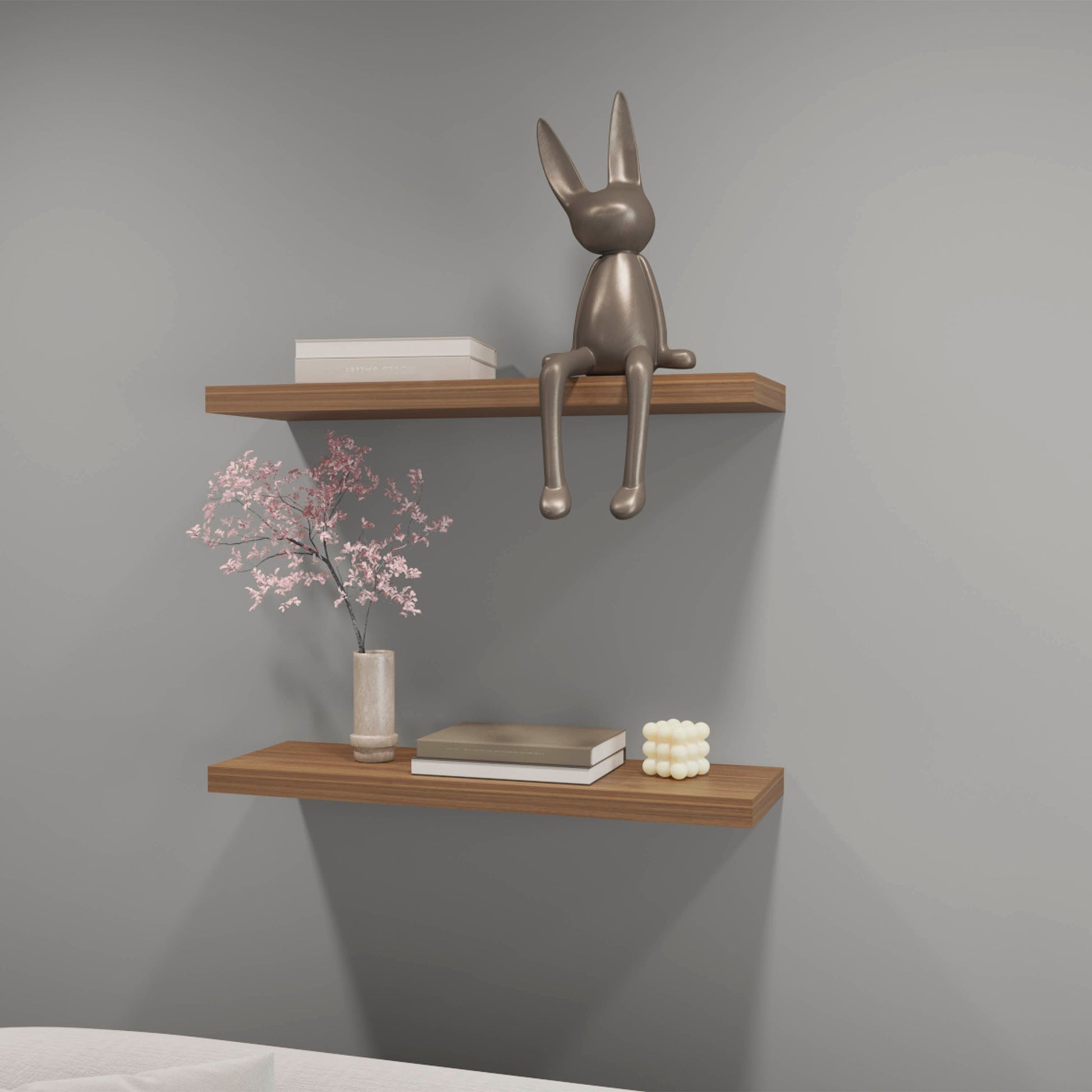 Polished metallic rabbit sculpture sitting on a wooden shelf
