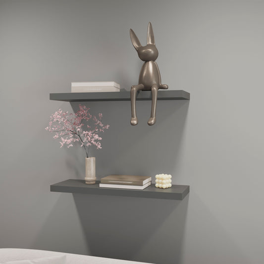 Metallic bunny figurine on a gray shelf