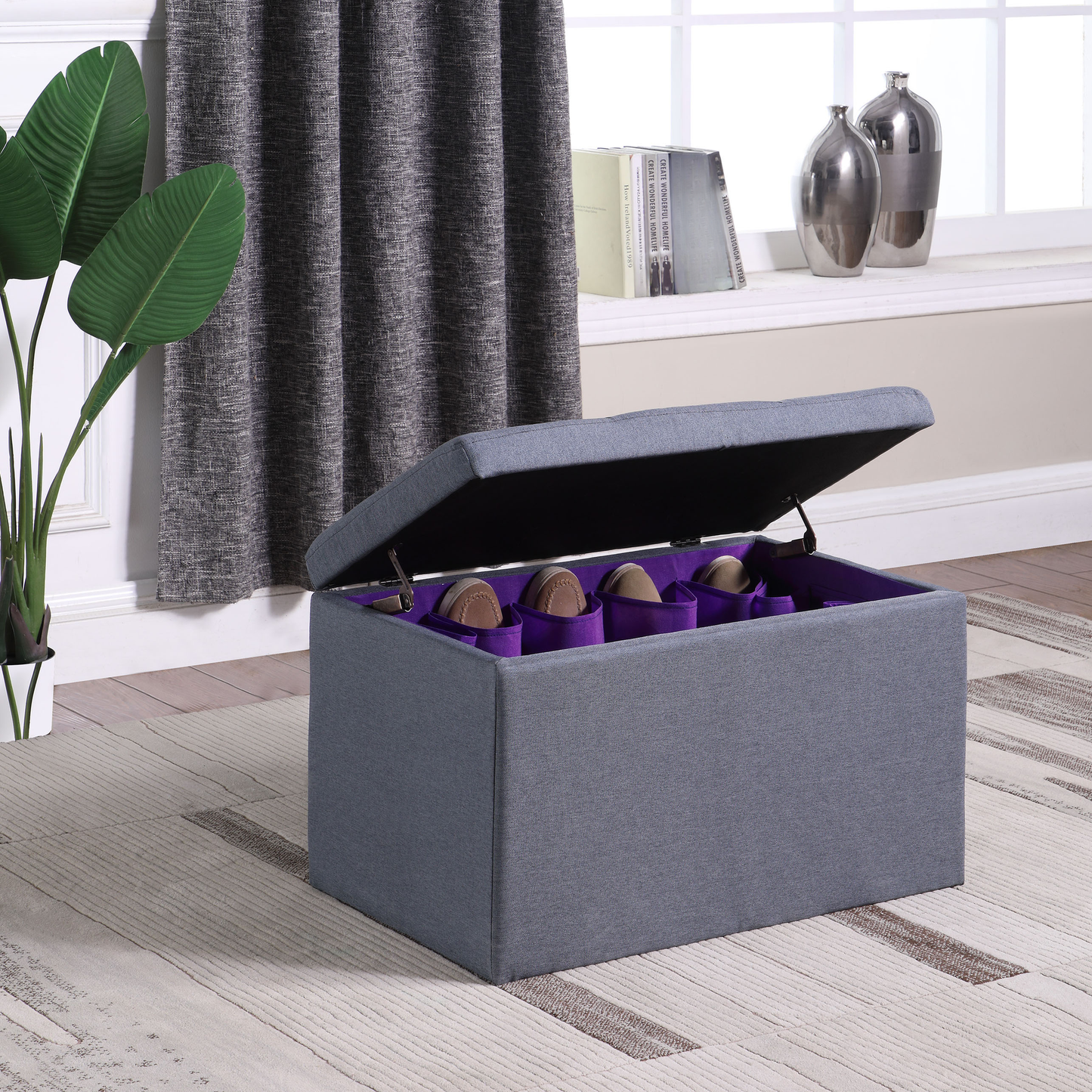 Grey fabric ottoman bench with open lid revealing shoe storage compartments