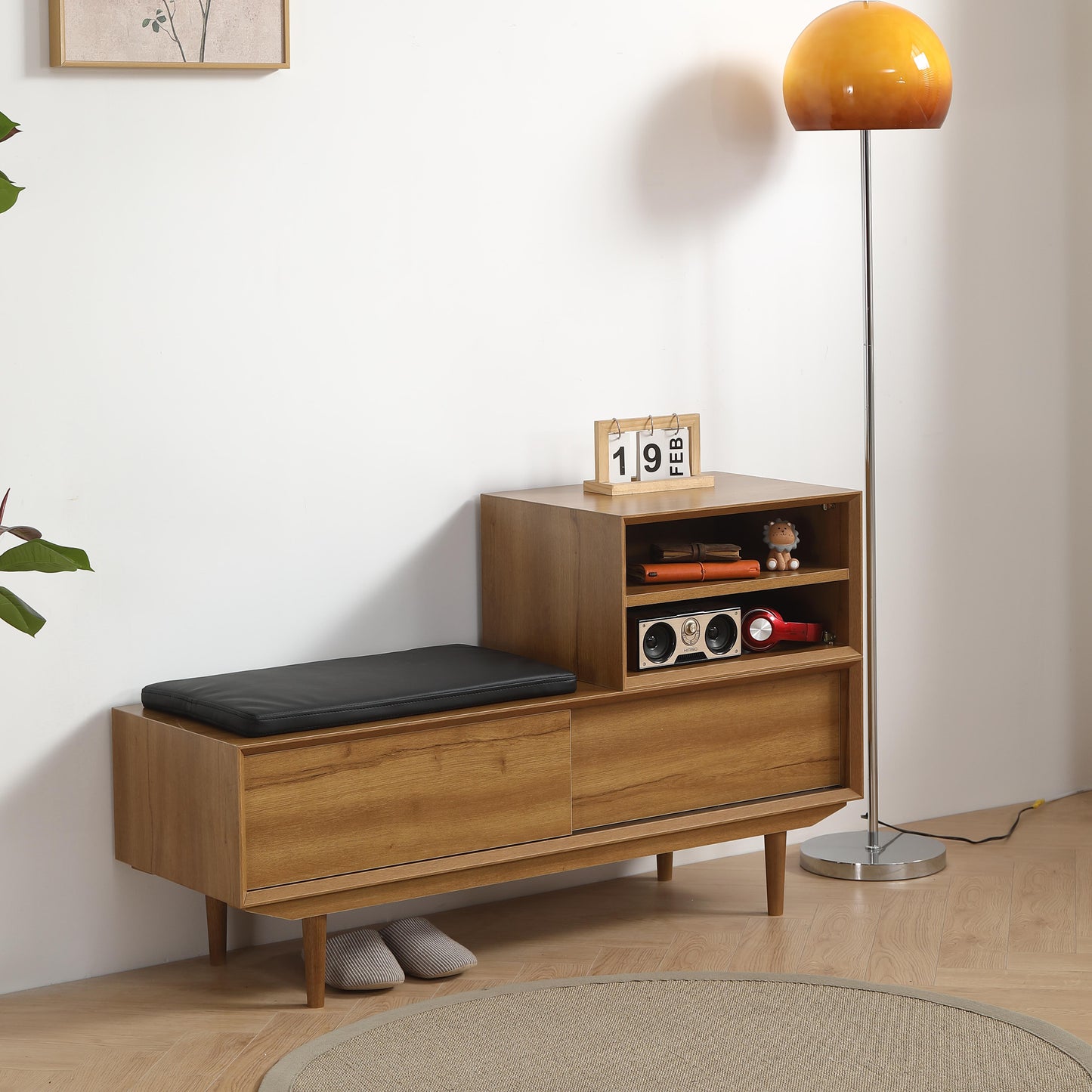 Wooden storage bench with black cushion