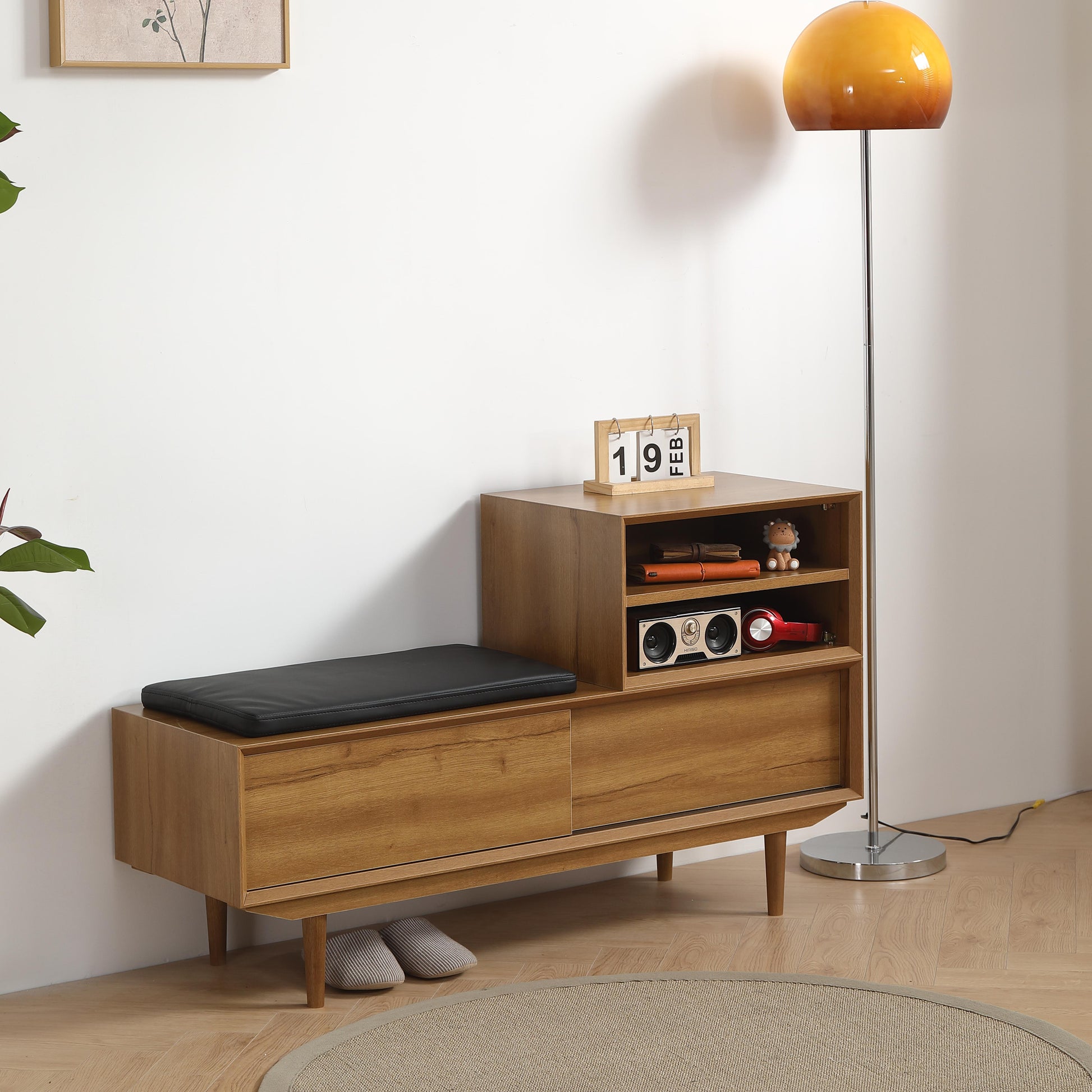 Wooden storage bench with black cushion