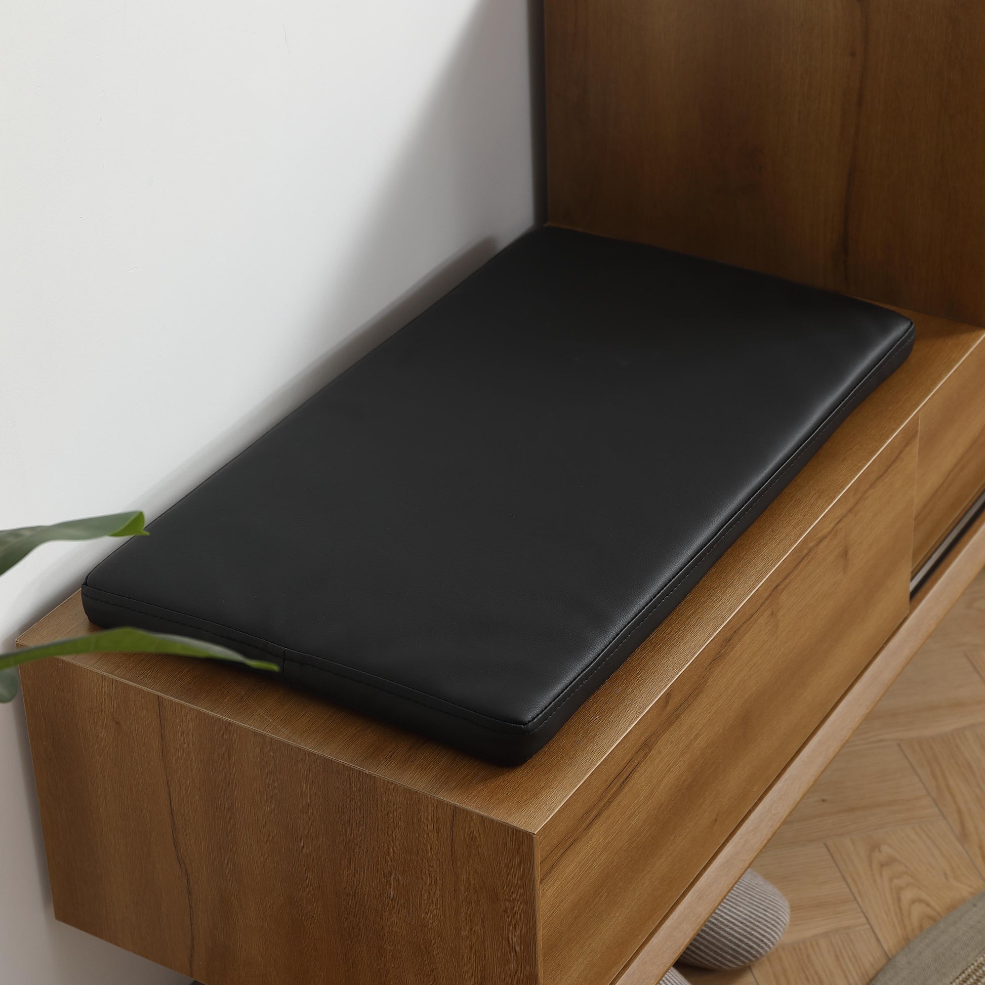Black faux leather bench cushion with stitched edges