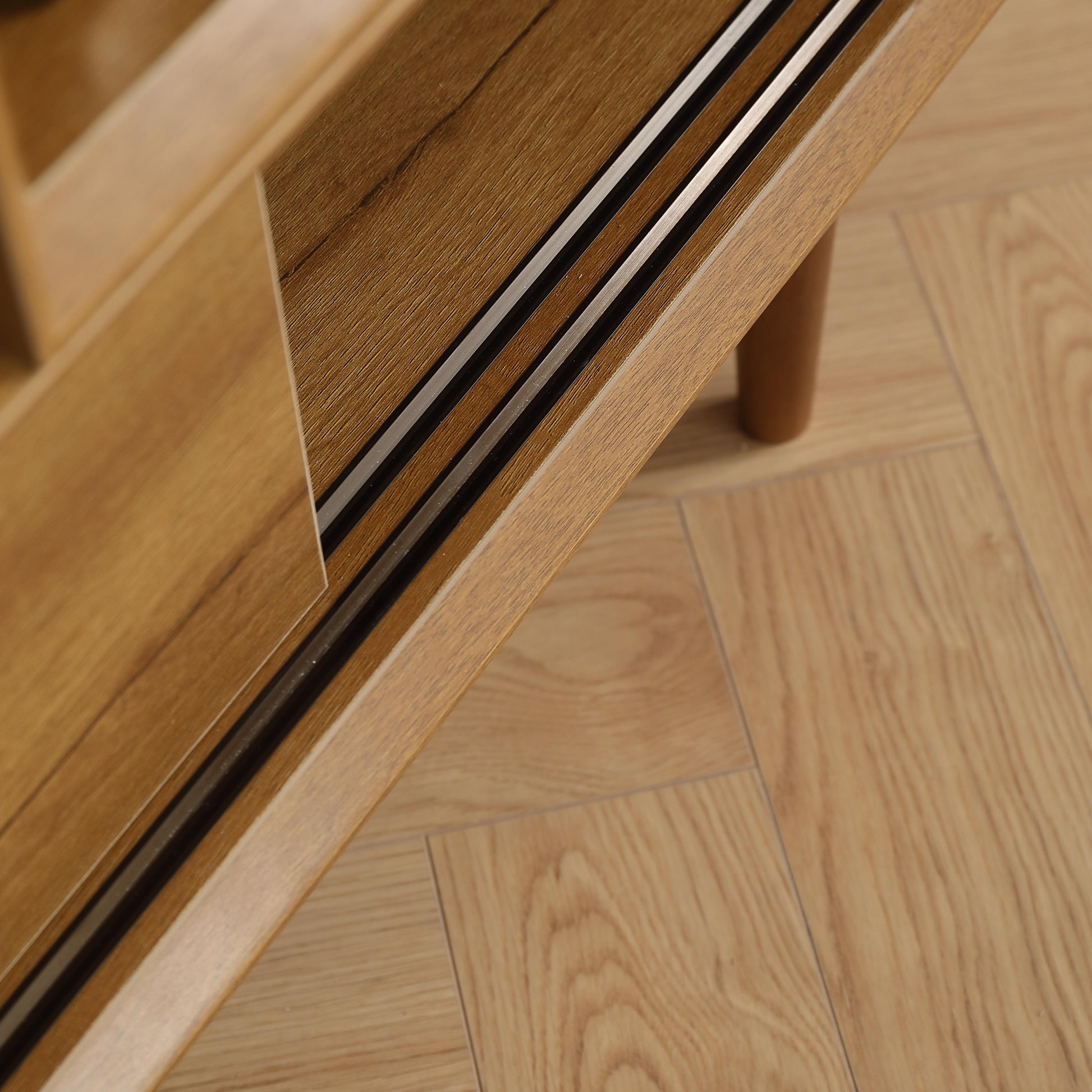 Wooden cabinet door with silver and black trim detail