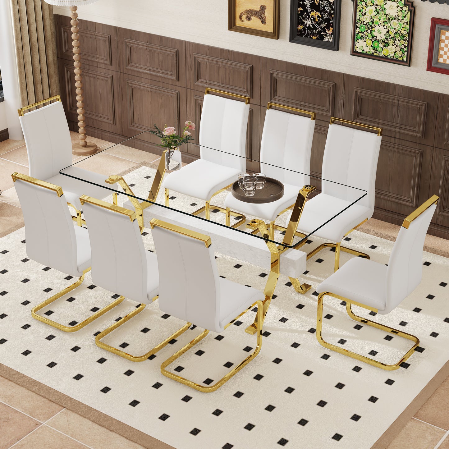 White leather dining chairs with gold frames around a glass tabletop