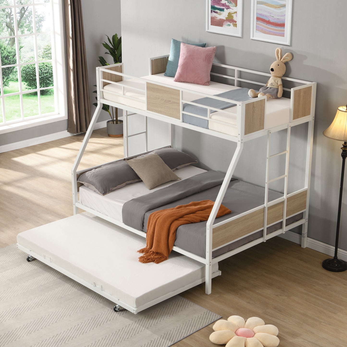 White metal triple bunk bed with pullout trundle and woodgrain accents