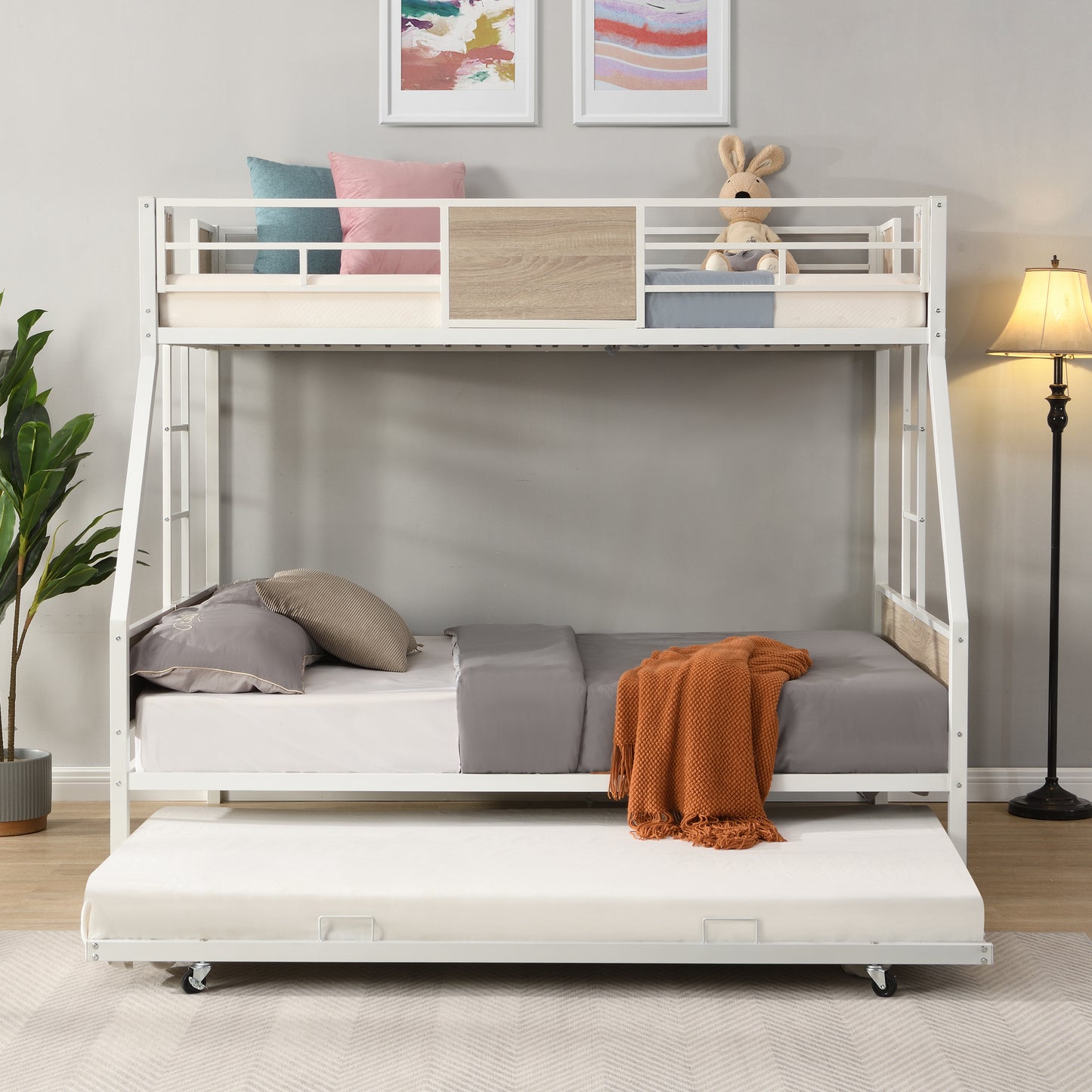 White metal triple bunk bed with pullout trundle natural wood accents ideal for kids