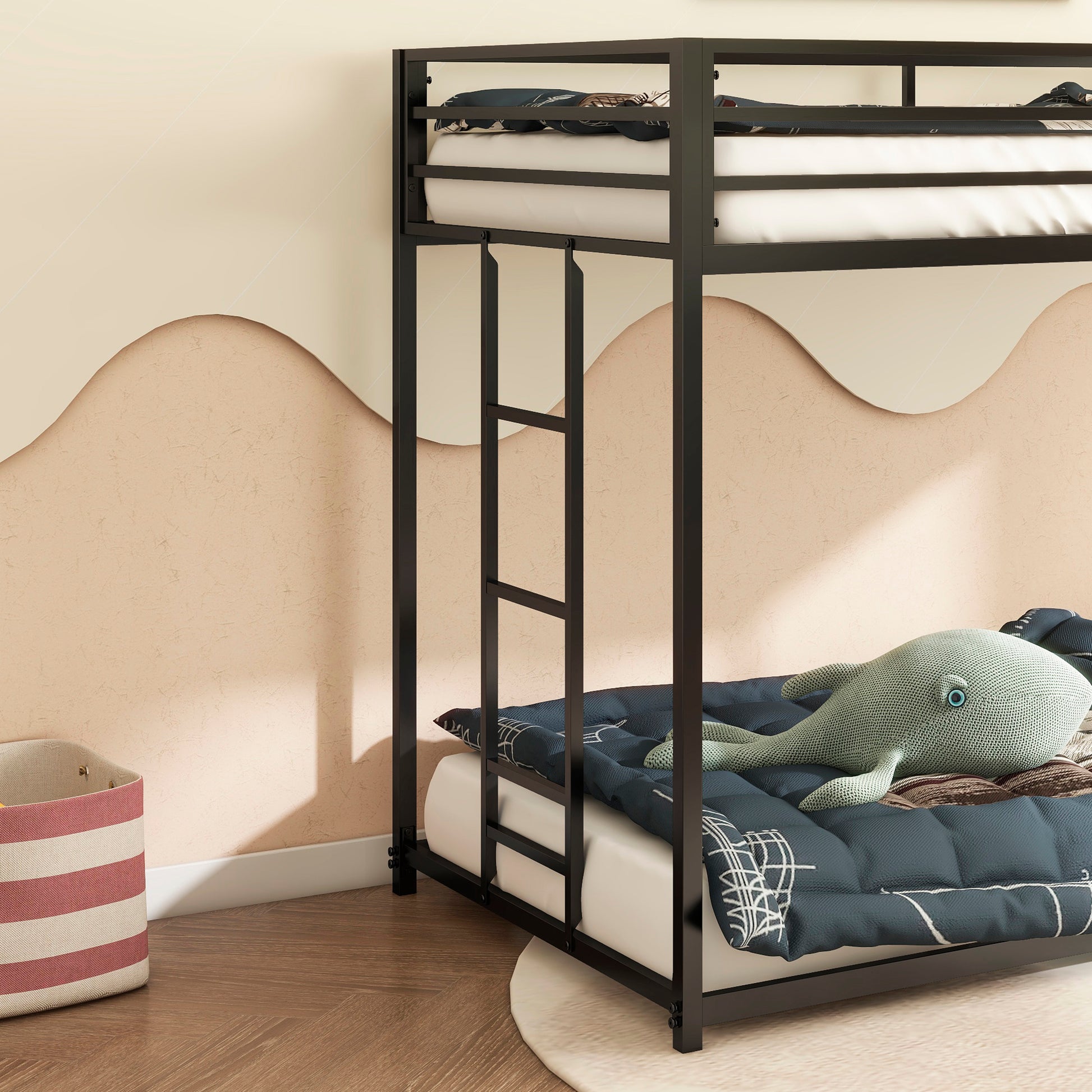 Black metal bunk bed with white mattresses and navy patterned bedding