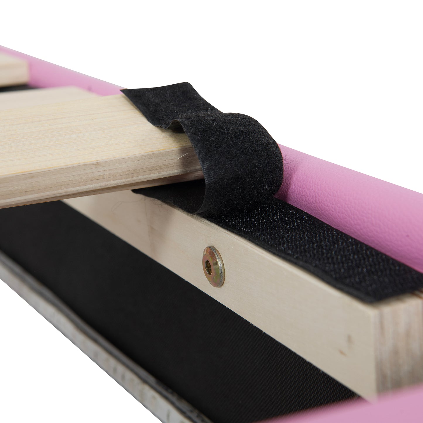 Closeup of black velcro strap attached to wooden frame with pink upholstery