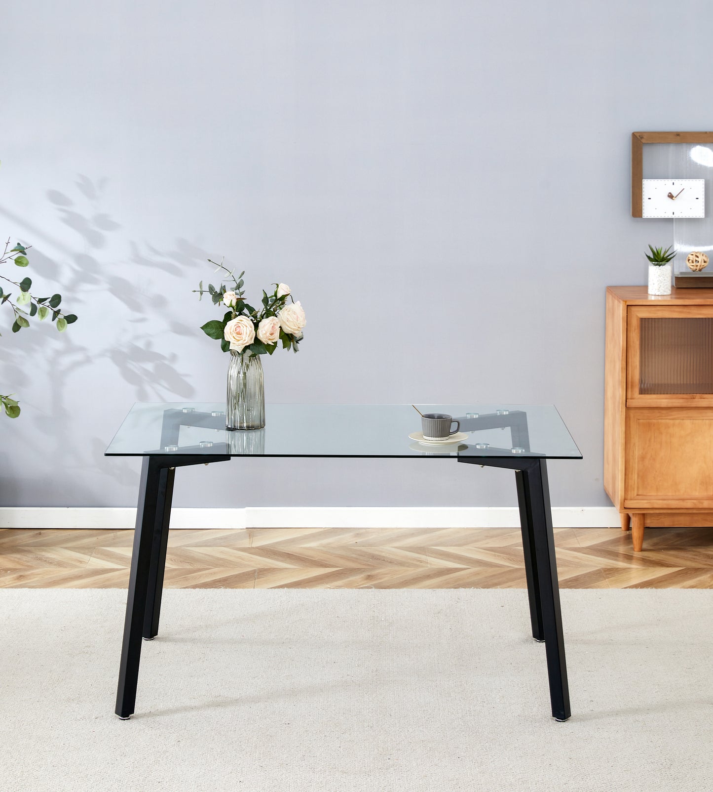 Modern glass dining table with sleek black metal legs