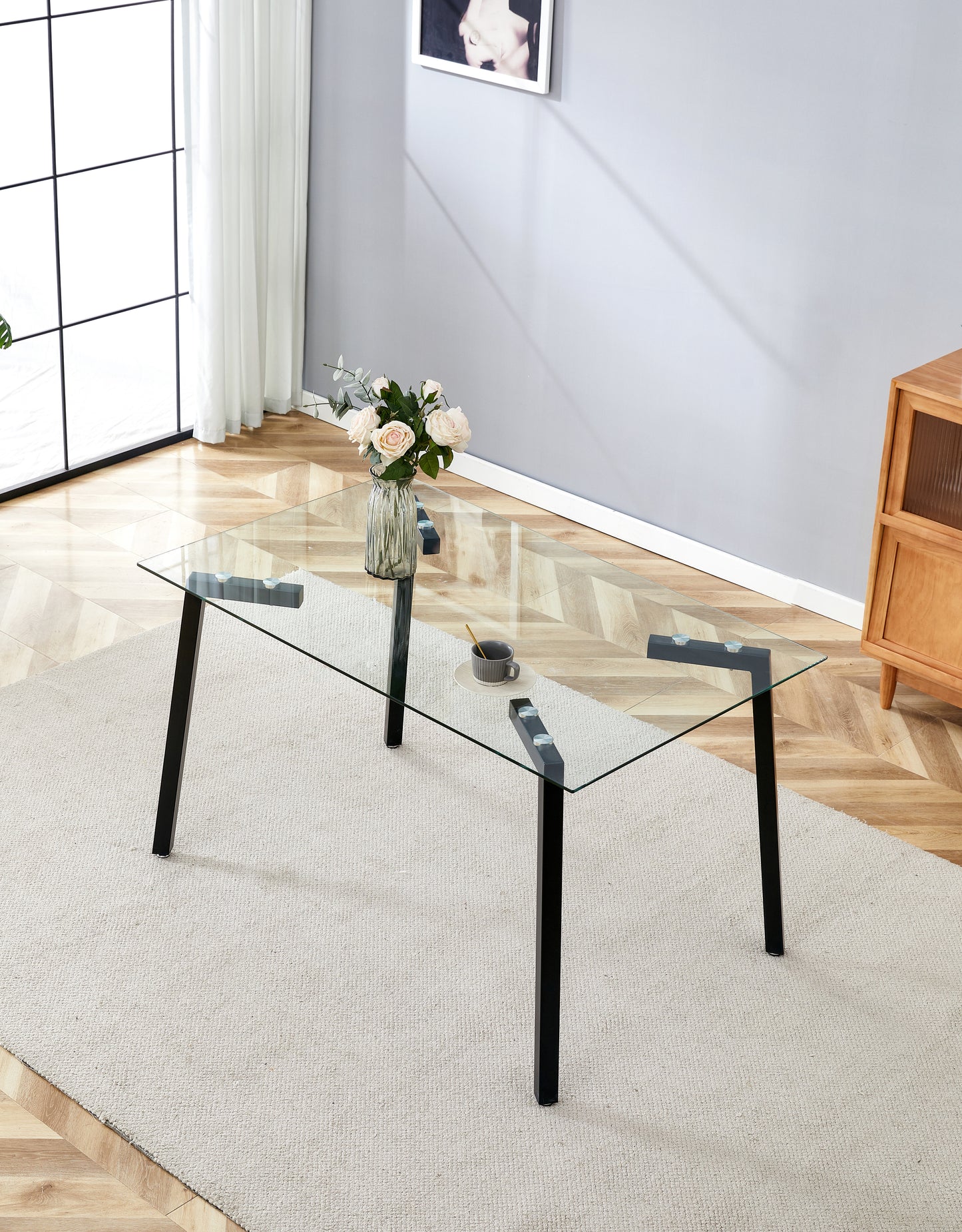 Rectangular clear glass coffee table with black metal legs