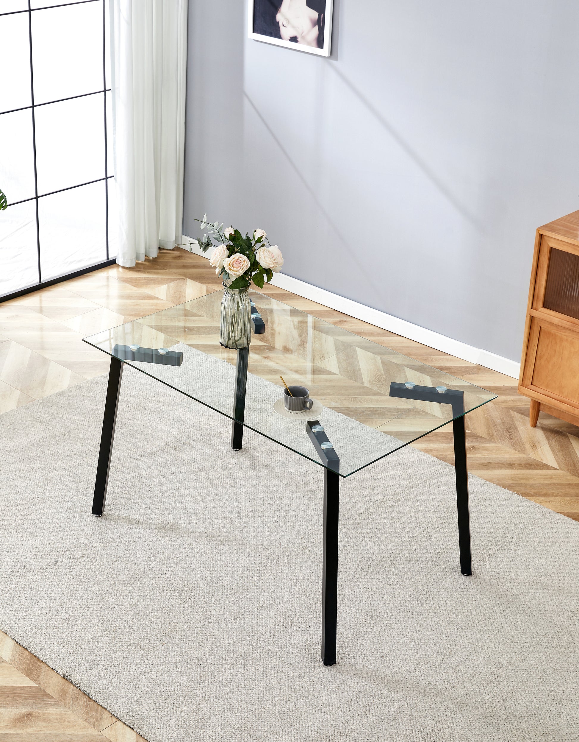 Rectangular clear glass coffee table with black metal legs