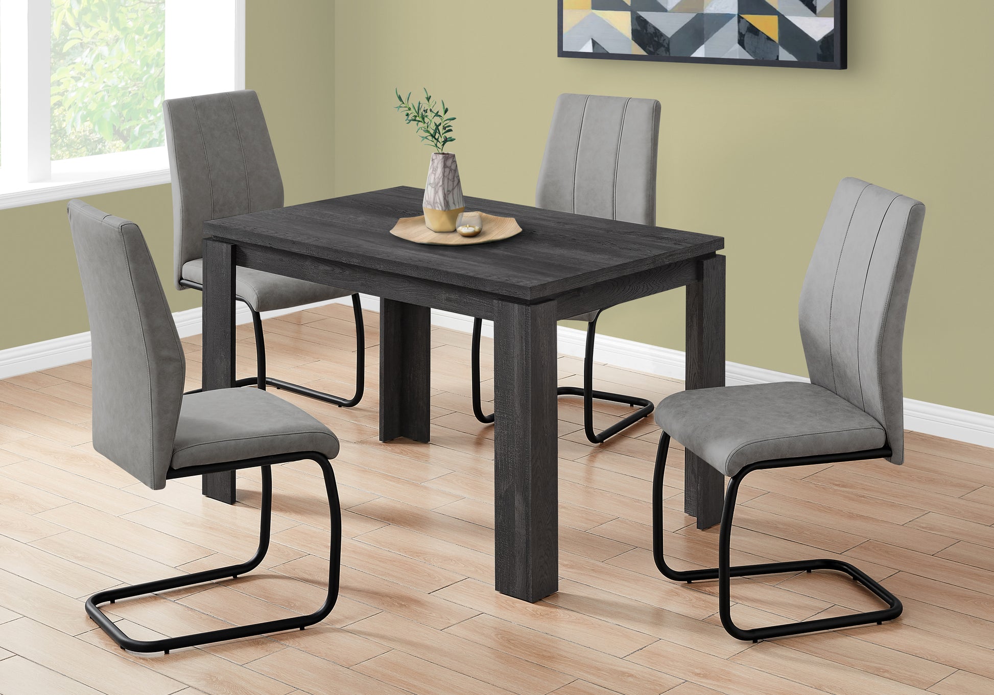 Dark wood dining table with four gray upholstered chairs