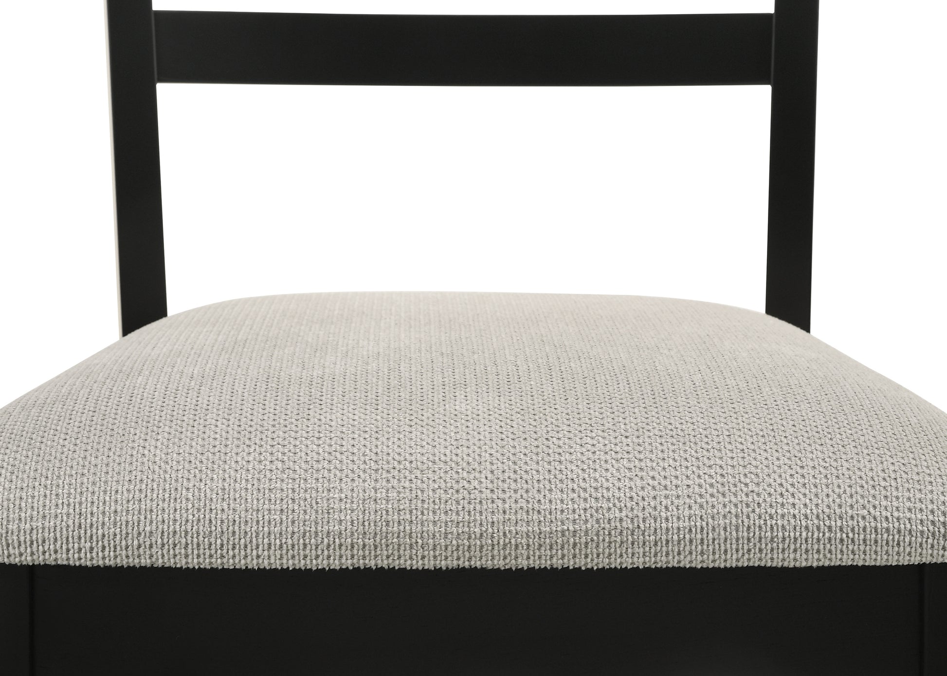 Closeup of light grey textured fabric seat on a black wooden chair