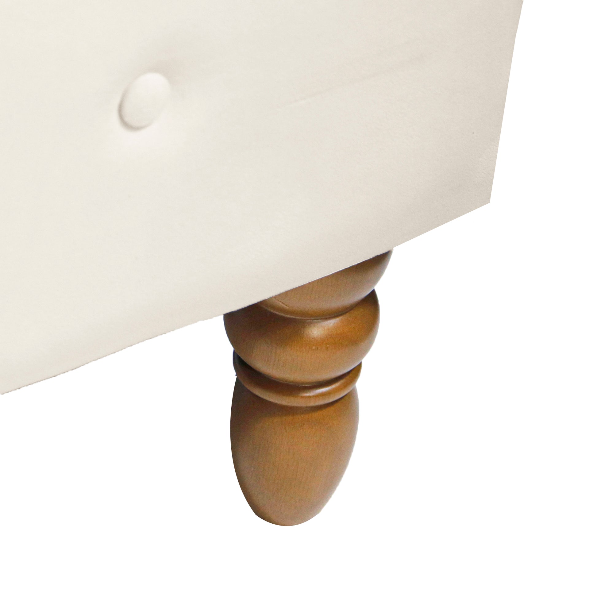 Cream upholstered armchair leg detail