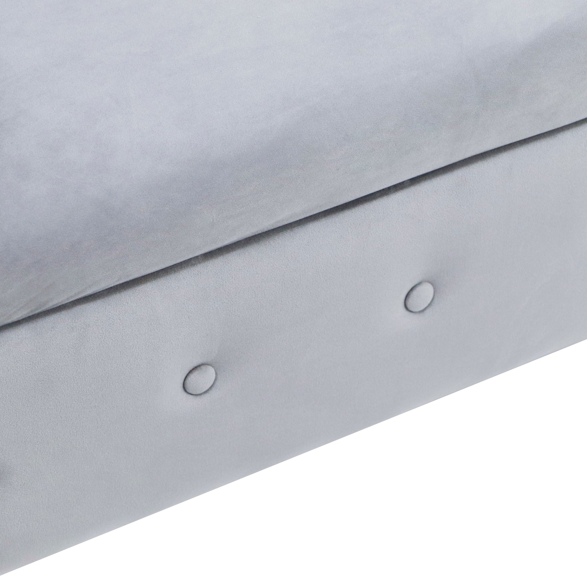 Light grey velvet sofa detail with subtle tufting