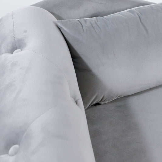 Tufted grey velvet armchair detail with button tufting and plush cushion