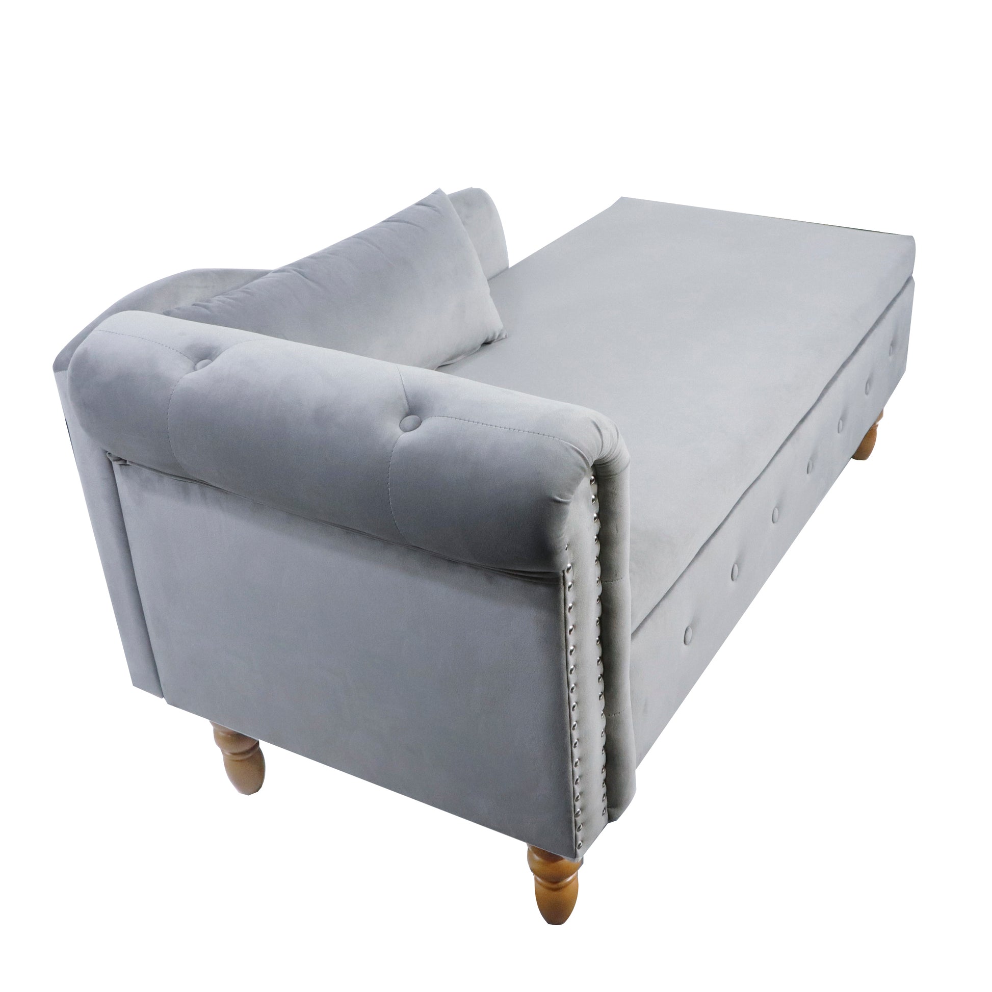 Grey velvet chaise lounge with tufted details and silver nailhead trim