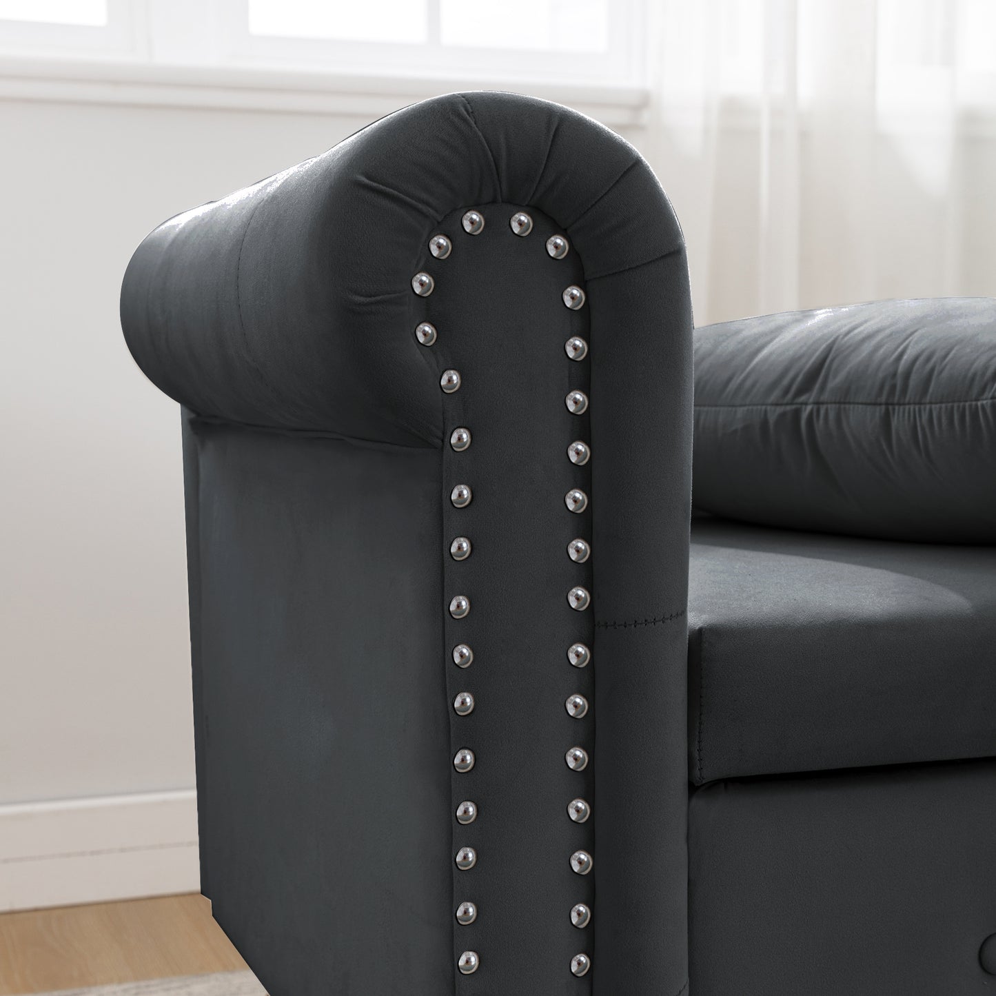 Dark gray velvet chesterfield sofa arm with silver nailhead trim
