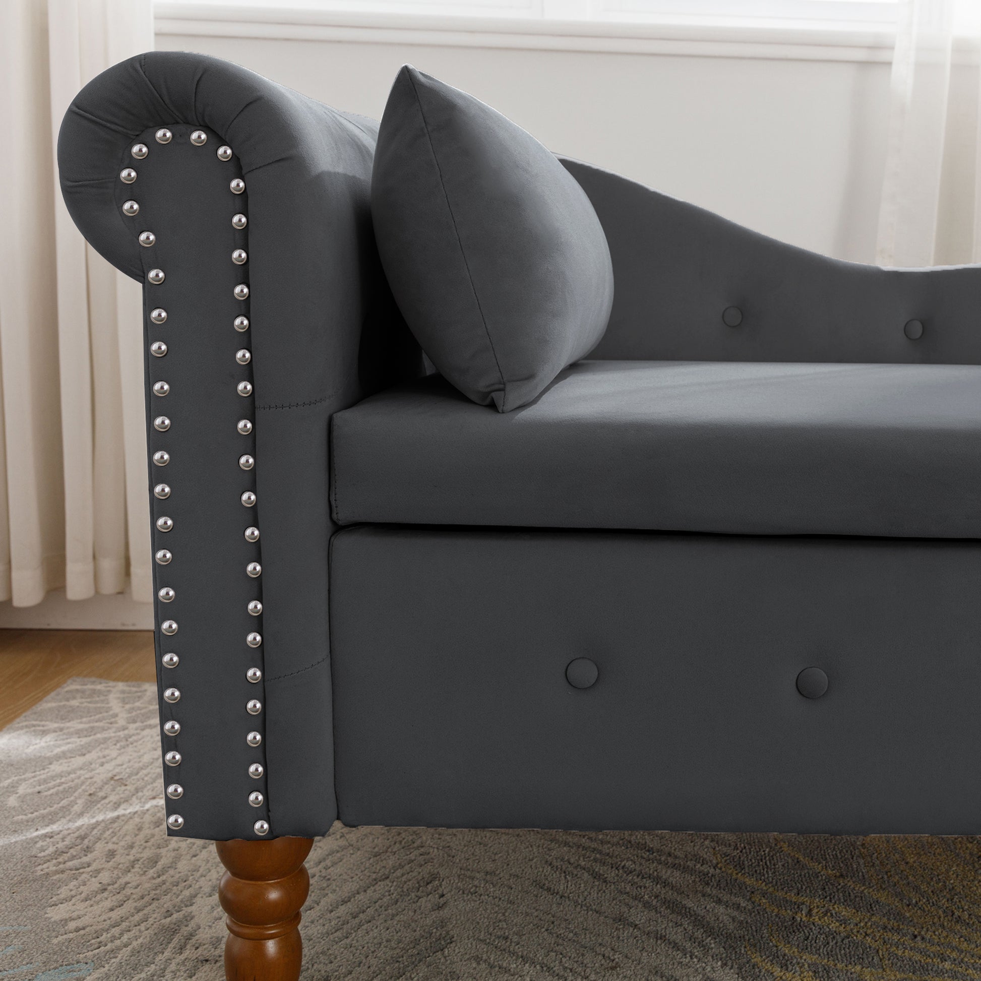 Dark grey velvet chaise lounge with silver nailhead trim and tufted details