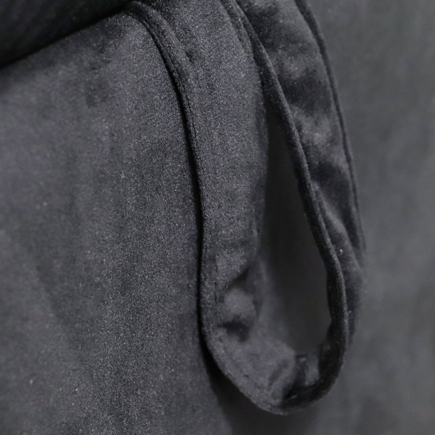 Closeup of a black velvet fabric texture with soft folds perfect for upholstery