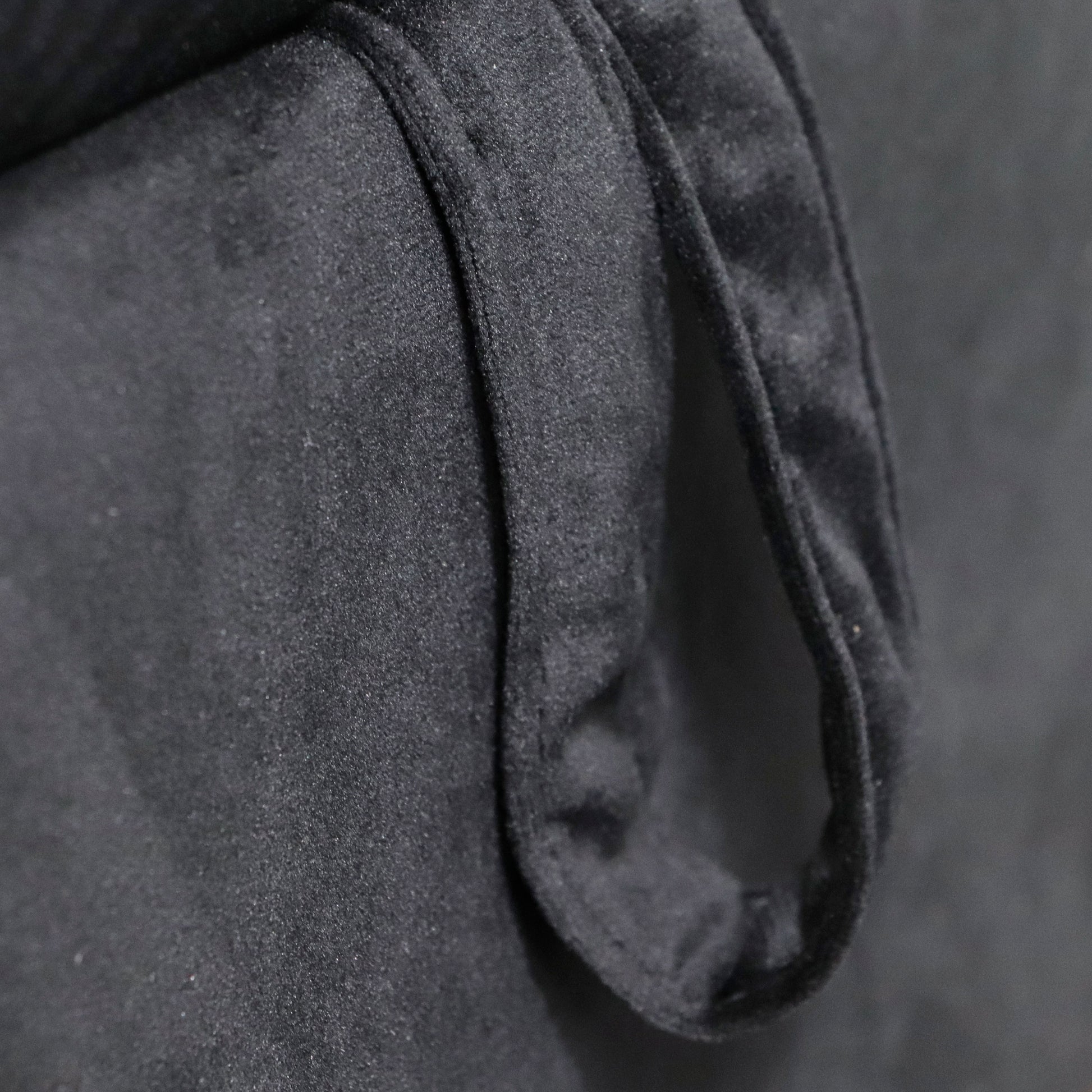 Closeup of a black velvet fabric texture with soft folds perfect for upholstery