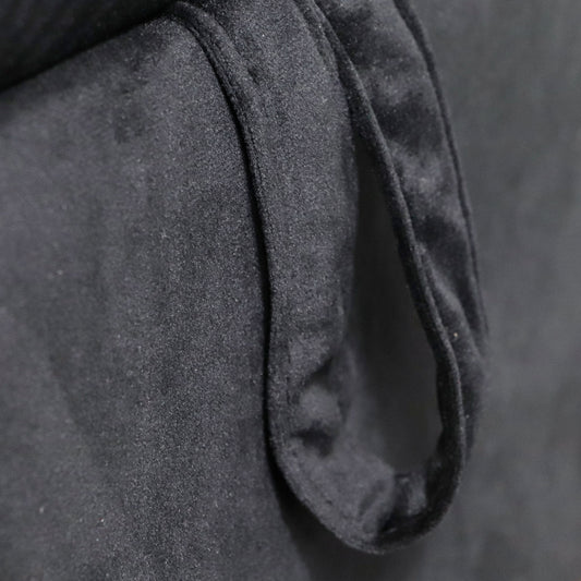 Closeup of a black velvet fabric texture with soft folds perfect for upholstery