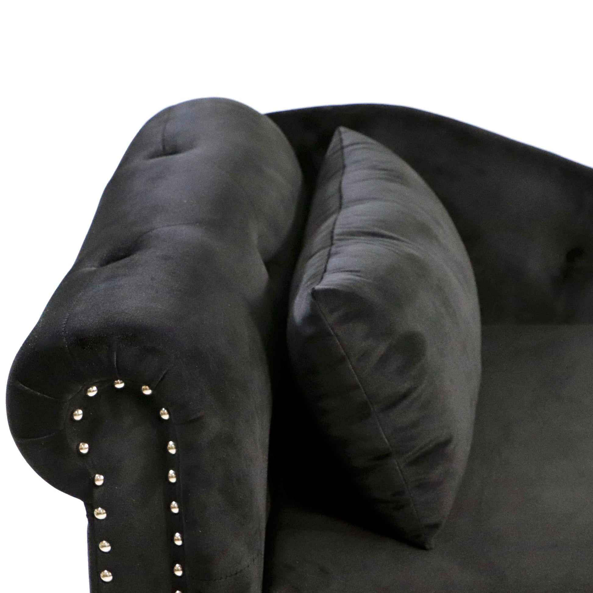 Black velvet armchair with button tufting and silver nailhead trim