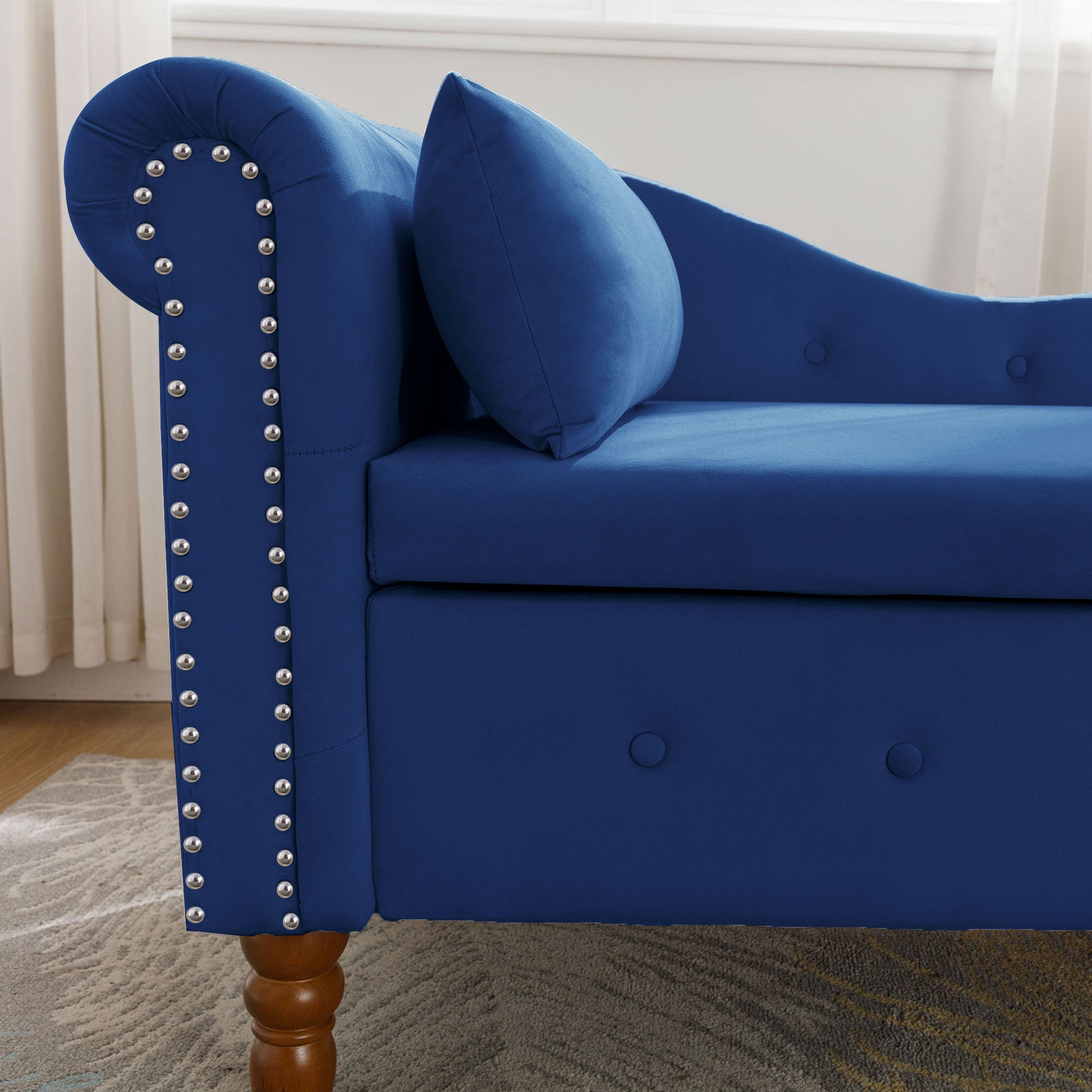 Deep blue velvet chaise lounge with silver nailhead trim and tufted buttons