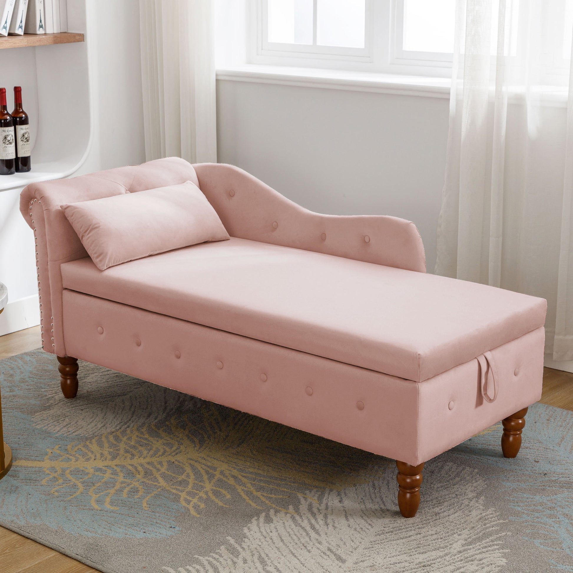 Pink velvet chaise lounge with tufted accents and storage