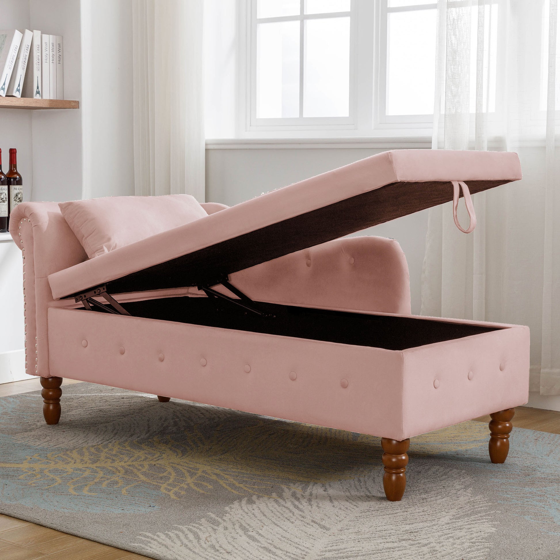 Pink velvet chaise lounge with open storage compartment