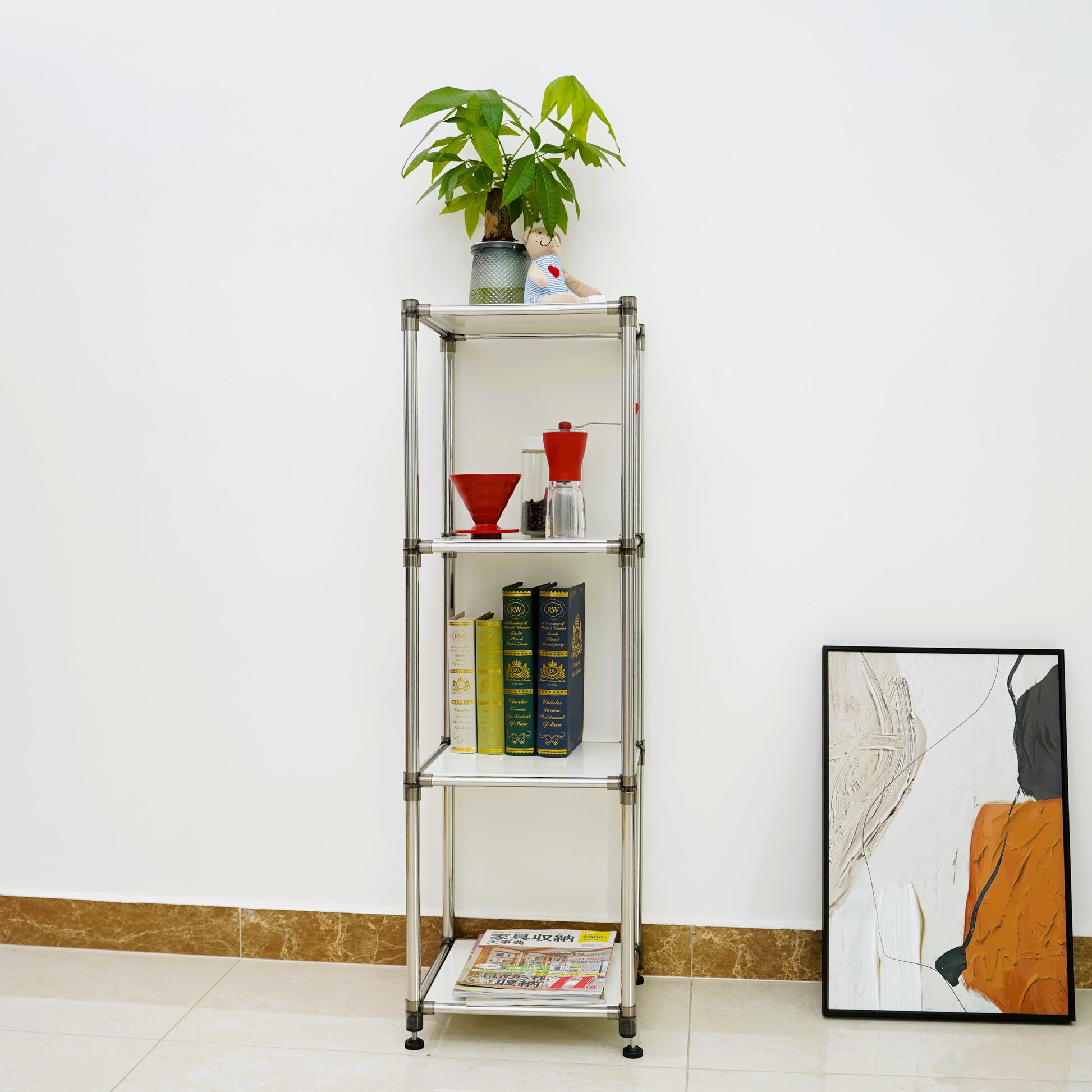 Silver metal shelving unit with decorative items and books displayed