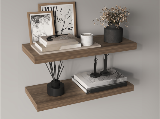 Wooden floating shelf with stacked books and framed art