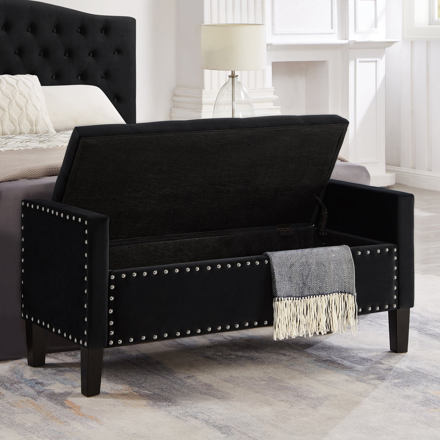 Black velvet storage bench with silver nailhead trim