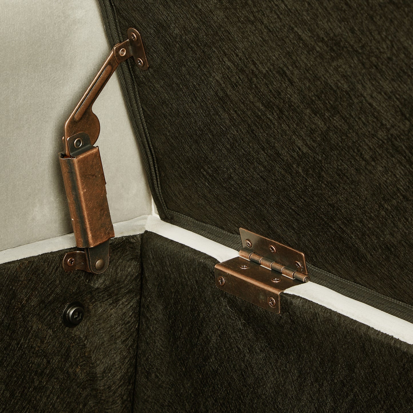 Antique brass hinge on velvet storage ottoman