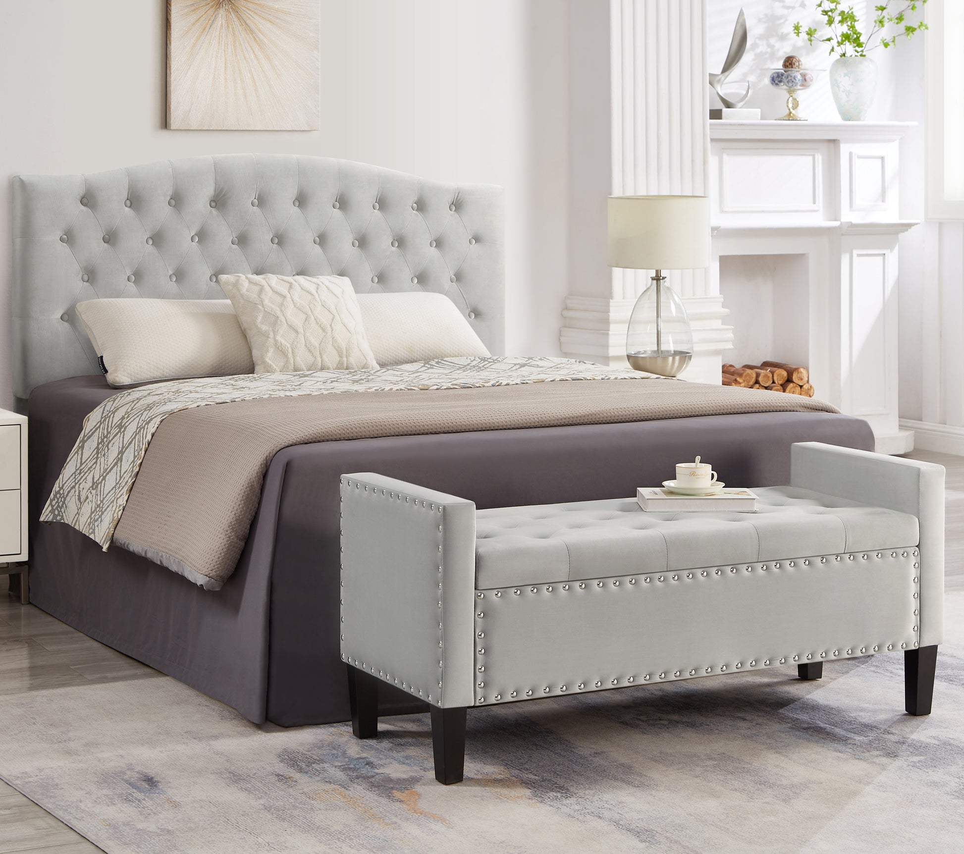 Light gray tufted upholstered storage ottoman with silver nailhead trim