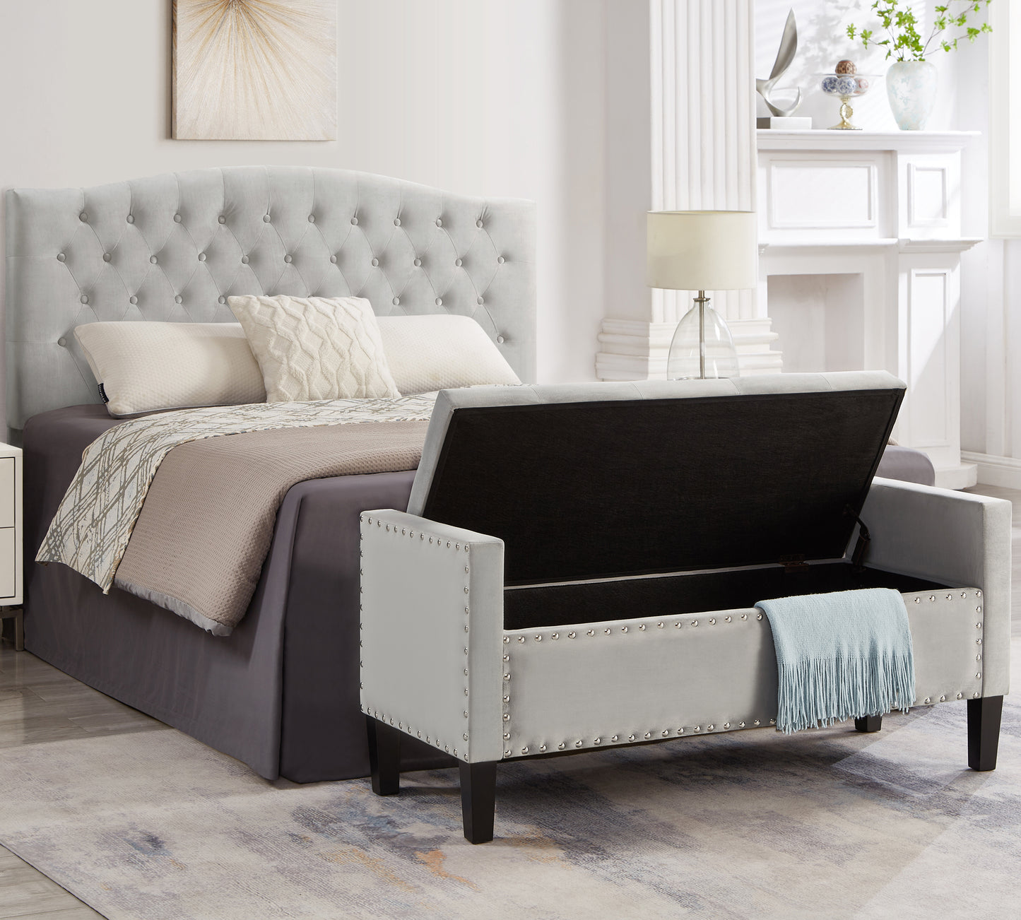 Tufted grey velvet storage bench with silver nailhead trim and open lid