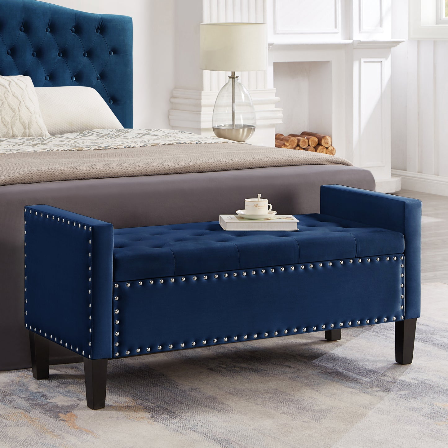 Navy blue velvet storage bench with silver nailhead trim and tufted seat